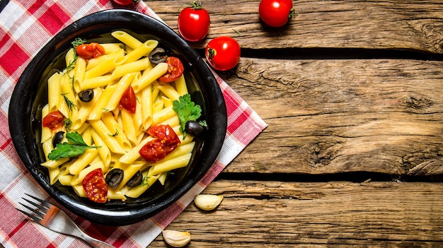 Pasta with tomatoes, olives and herbs.