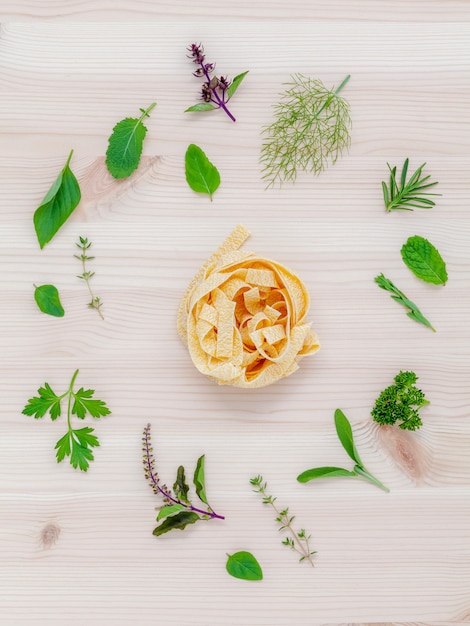 Pasta with vegetables on wooden background.