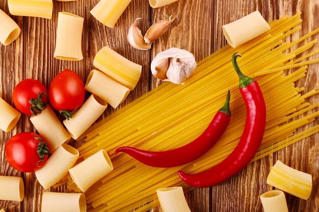 Pasta on the wooden chili, pepper, garlic