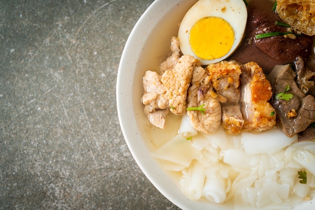 paste of rice flour or boiled Chinese pasta square with pork in clear soup - Asian food style