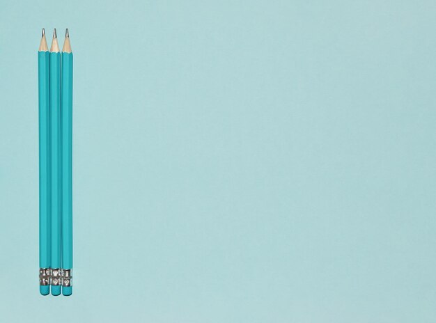 Photo pastel blue pencils with erasers on blue background back to school concept copy space flat lay