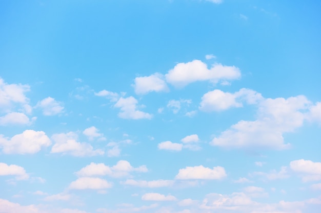 明るい白い雲とパステルブルーの春の空-自然な背景