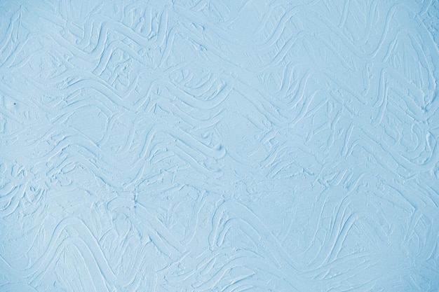Pastel blue wall background with embossed abstract pattern