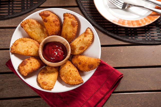 Photo pastel, a brazilian snack, with a bar