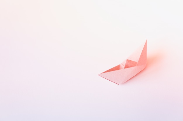 Pastel color paper boat on clean background with copy space