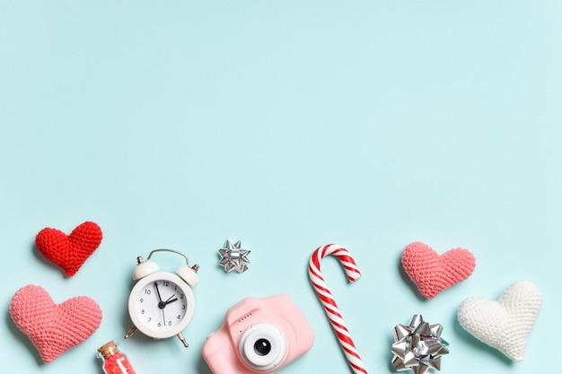 A pastel-colored banner with a camera, lollipops, hearts and bows.