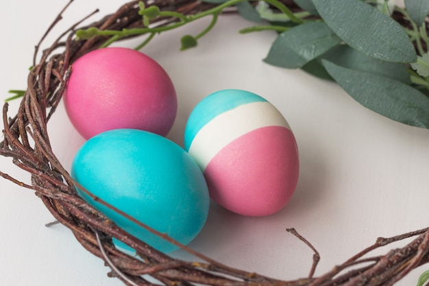 Pastel colored Easter eggs on white table