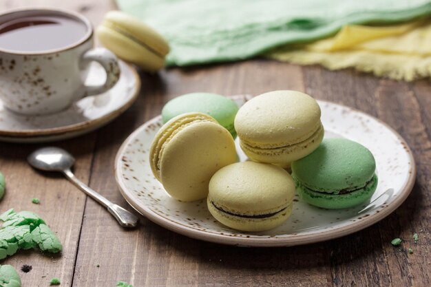 Pastel colored macaroons on a dark background