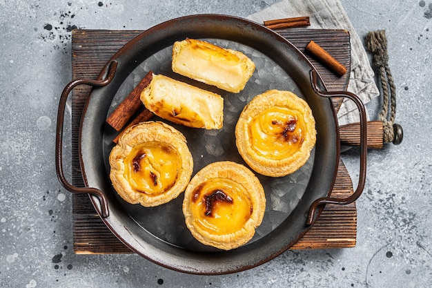 Pastel de nata traditional Portuguese egg custard tart Gray background Top view