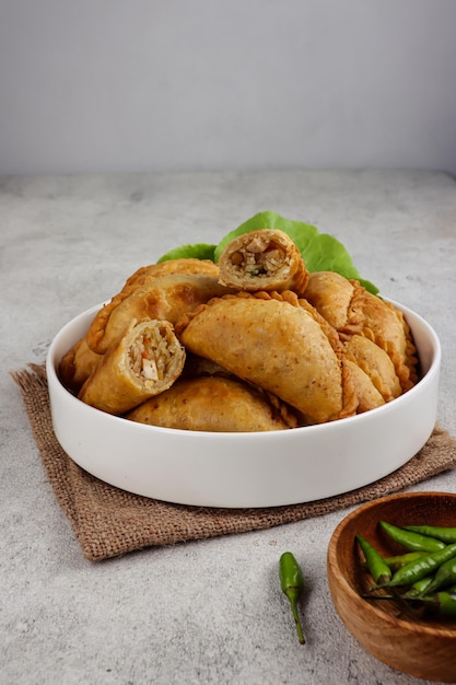pastel goreng is potato empanadas fried pastry with filling of sauted vegetable and chicken