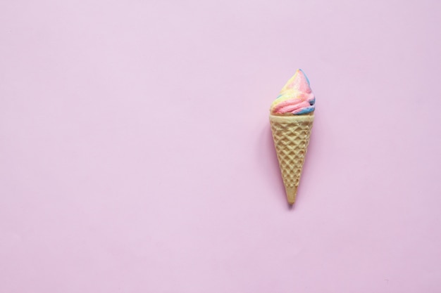 Pastel meringue cone on pink background