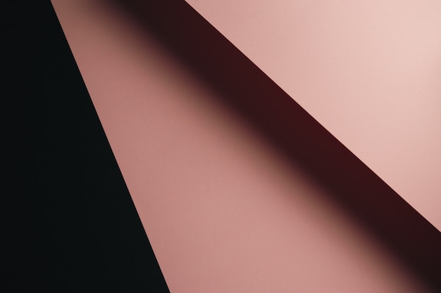 pastel pink and black flat lay background with sharp layers and shadows with copy space