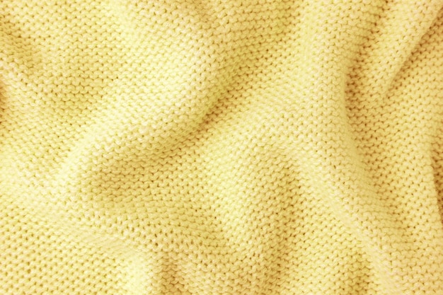 パステル イエロー ニット ウール生地テクスチャ背景抽象的な繊維の背景