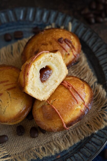 Pasticciotto leccese pastries on a dark blue plate on dark table typical apulian breakfast close up table decorated with coffee beans and juta