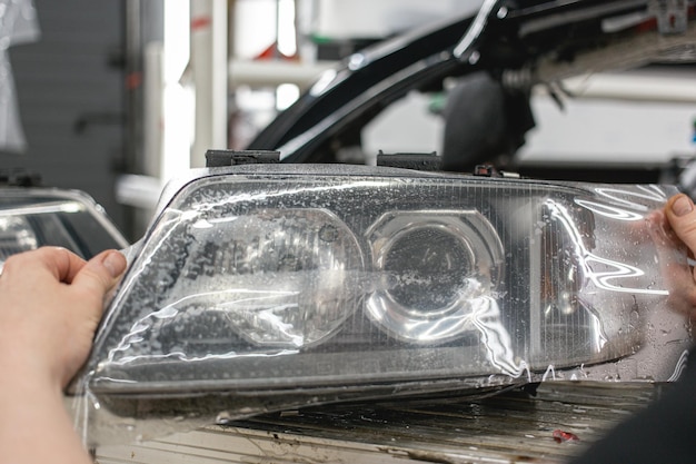 Pasting a protective polyurethane film to protect against chipping on the car headlight glass