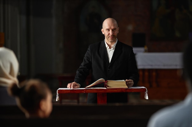 Pastor reading bible for believers