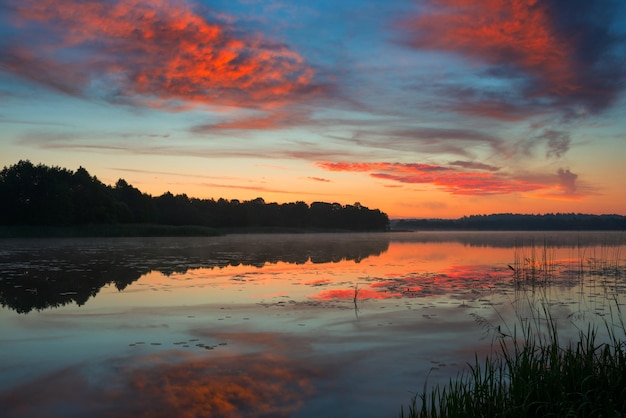 Pastoral landscape with dramatic sky on the lake in Belarus