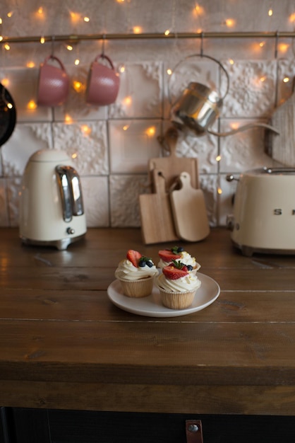 Pastries decorated with berries in the kitchen in a modern interior