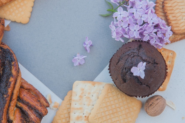 Pastries and lilac, flat lay