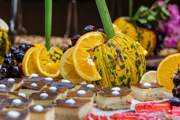 Pastries, sweet dessert and decorated fruit in the dining room at the tourist hotel, close up. Turkey