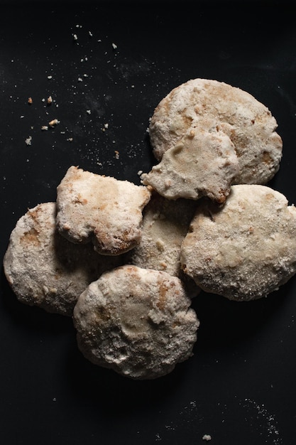 Pastries with powdered sugar and dark background