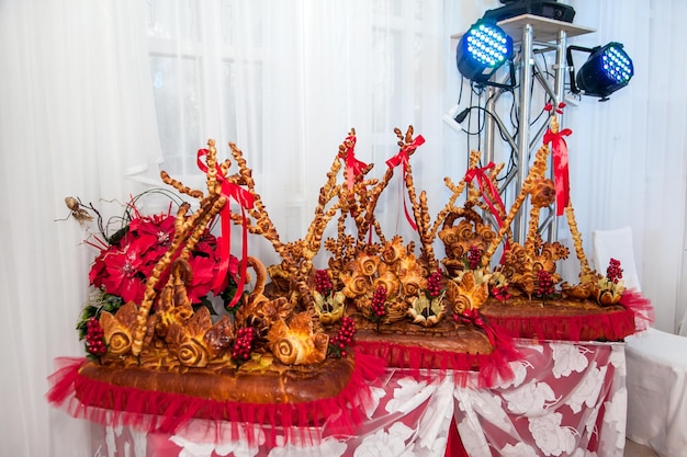 Pastry cakes stuffed with yeast dough decorated with figures and flowers made of dough bread art ornate wedding bread