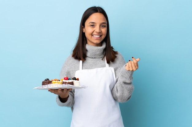 Pastry chef holding a plate with cakes