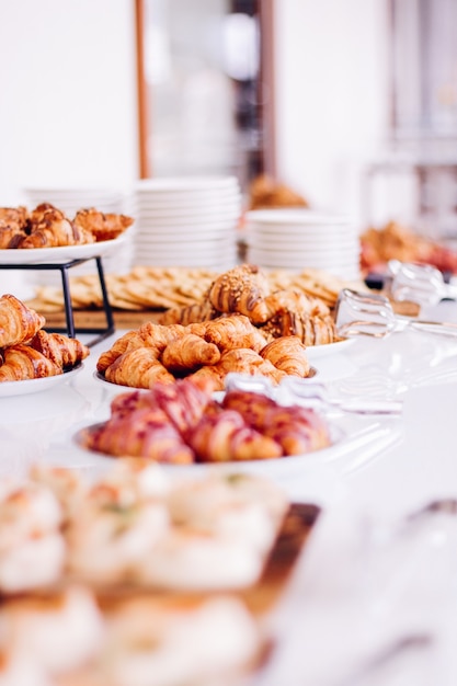 Pastry cookies and croissants sweet desserts served at charity event  food drinks and menu concept a...