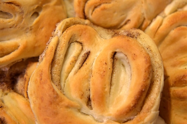 Pastry Variety of sweet pastry Bakery shop Baked products Freshly toasted buns with cinnamon and sugar rotating on turntable Breakfast or brunch concept Baked buns Top View Brioche scone