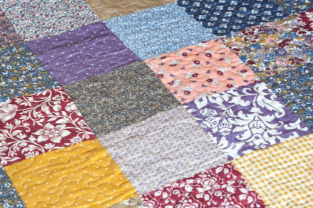 Photo patchwork print quilted quilt with patchwork print geometrical pattern selective focus