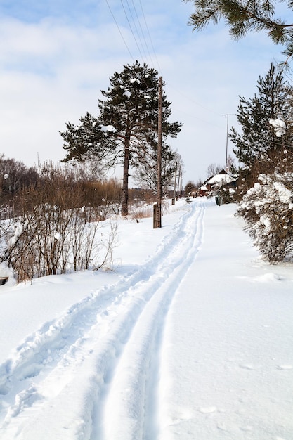 Path and ski run along little russian village