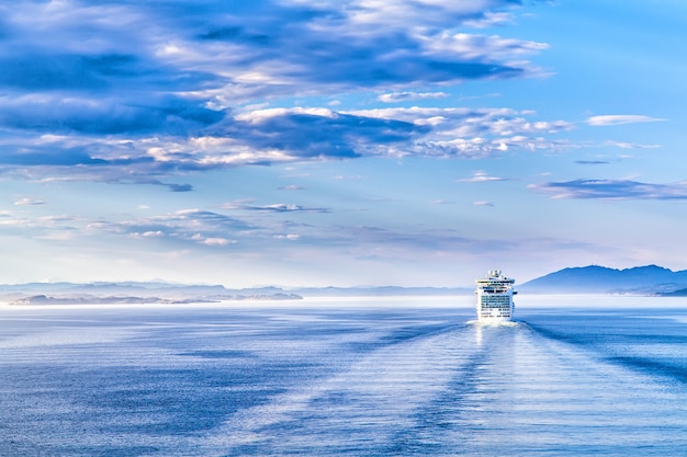 Path on the water from a large cruise ship