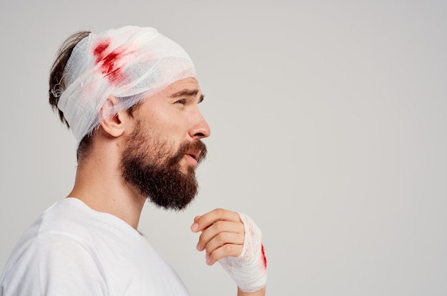 Patient bandaged head and hand blood treatment