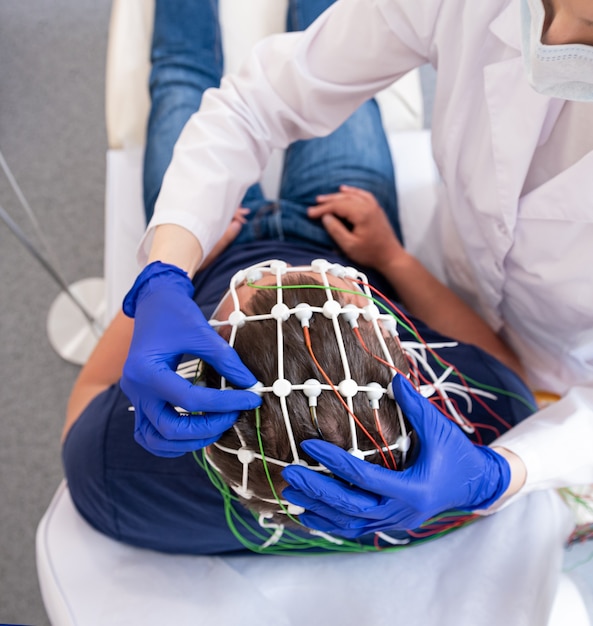 Patient brain testing using encephalography at medical center