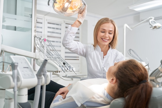 Patient consulting with dentist in clinic.