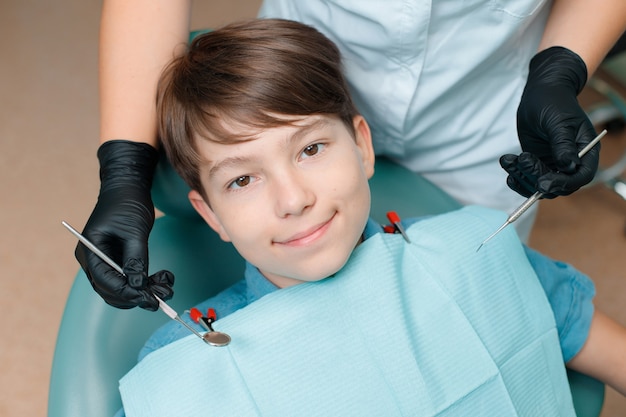 Patient in dental chair Teen boy having dental treatment at dentists office