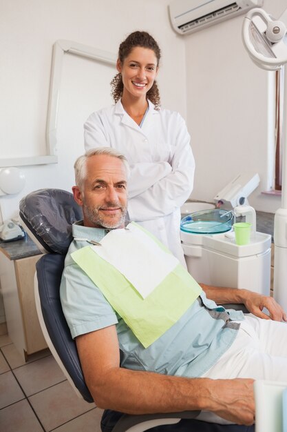 Patient and dentist smiling at camera