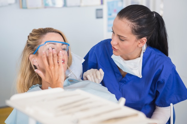 Patient and dentist talking about her toothache