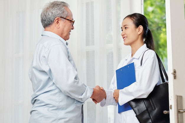 Patient and doctor shaking hands