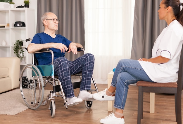 Patient and doctor talking in cozy apartment.