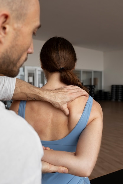 Photo patient doing physical rehabilitation helped by therapists