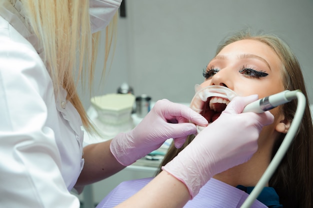 Photo patient examination and treatment at the dentist.