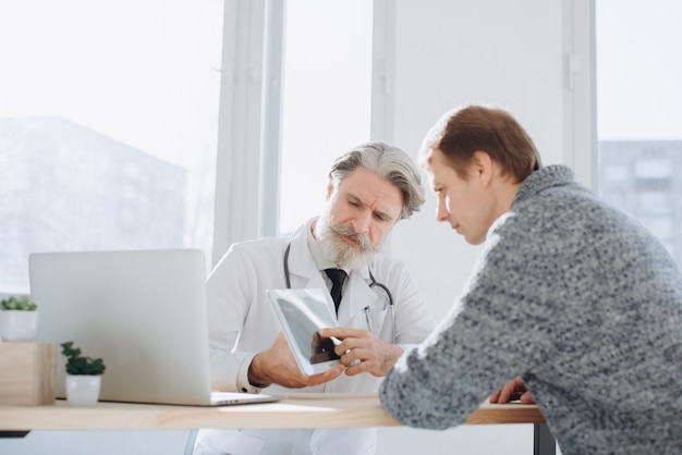 Patient having consultation with senior doctor in office