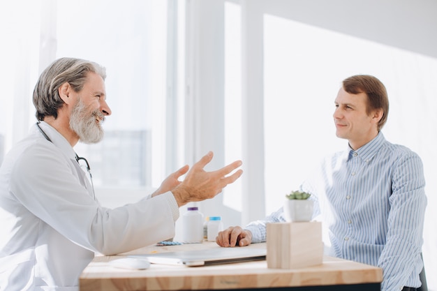 Patient having consultation with senior doctor in office