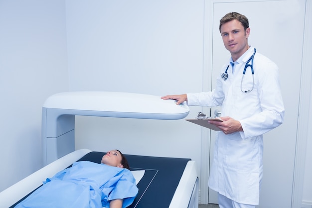 Patient is lying on the x-ray machine