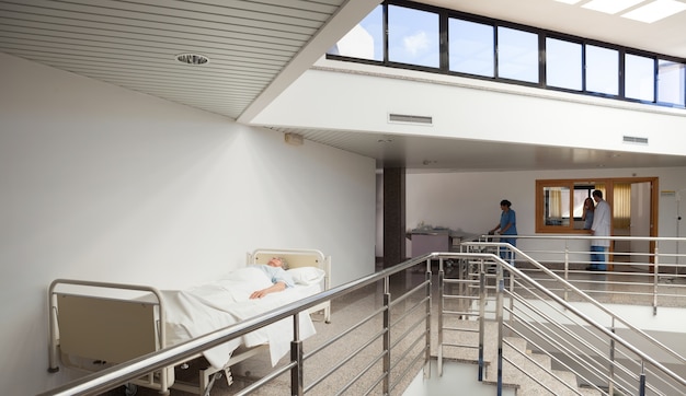 Patient lying in bed in corridor