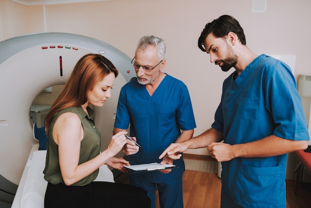 Patient Signs Paper Agreement for CT Examination.