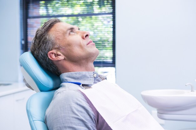 Patient sitting on dentist chair