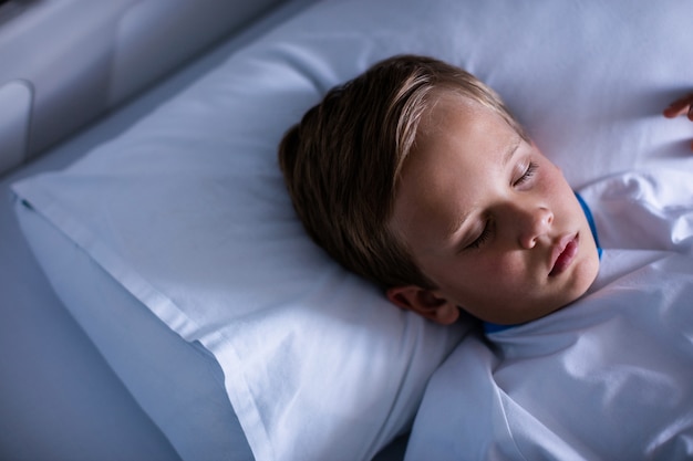 Patient sleeping on bed at hospital