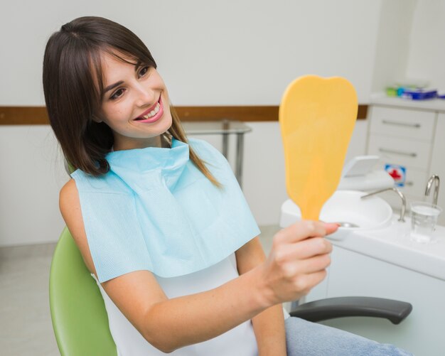 Patient smiling and looking in the mirror